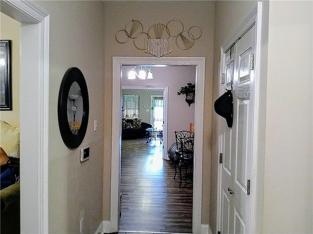 hallway with an inviting chandelier