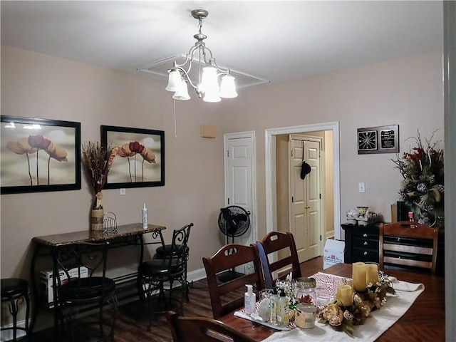 dining area featuring a chandelier and dark hardwood / wood-style floors