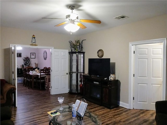 living room with ceiling fan and dark hardwood / wood-style floors