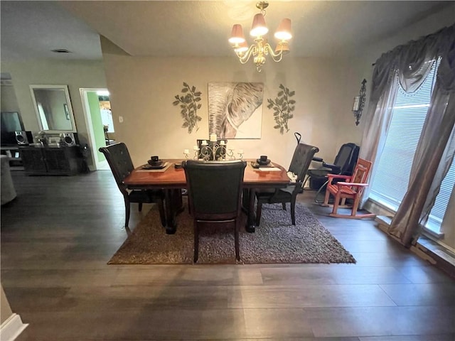 dining space with a chandelier and hardwood / wood-style floors