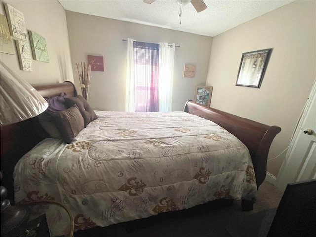 bedroom featuring a textured ceiling, ceiling fan, and vaulted ceiling