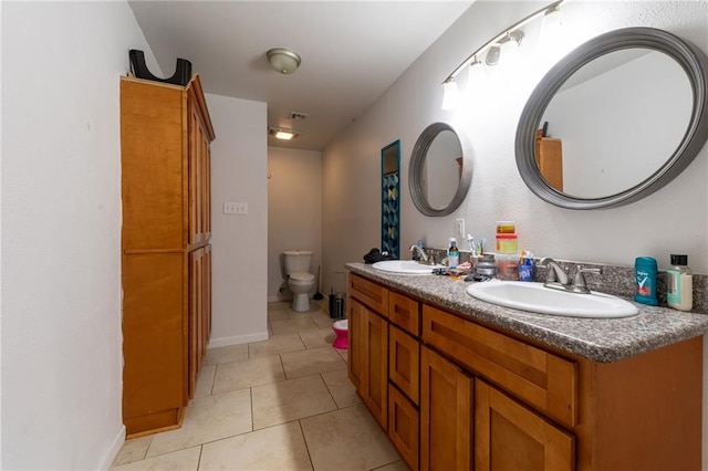 12461 Wardline Rd, Hammond, LA 70401 - bathroom featuring tile flooring, toilet, and double vanity
