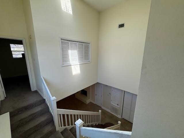 staircase featuring a towering ceiling