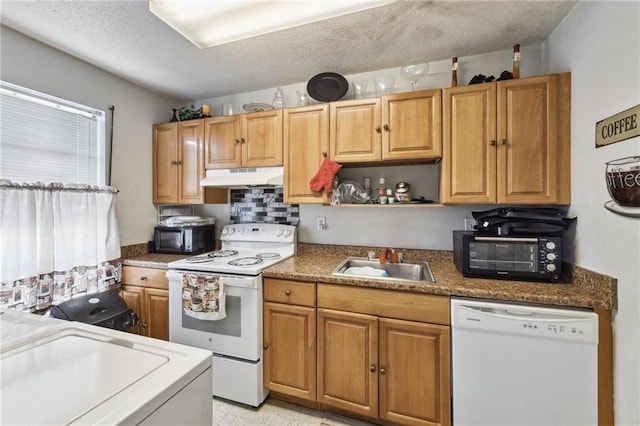 kitchen with white appliances, sink, light tile floors, backsplash, and a textured ceiling