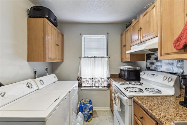 washroom featuring separate washer and dryer, a textured ceiling, and light tile floors