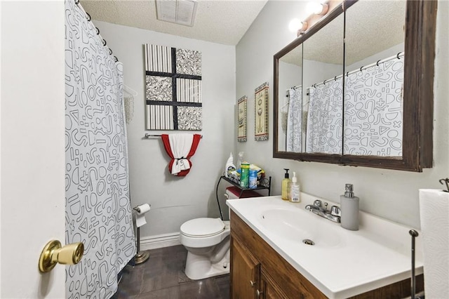 bathroom with a textured ceiling, tile flooring, toilet, and large vanity