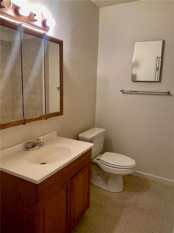 bathroom featuring tile floors, toilet, and vanity