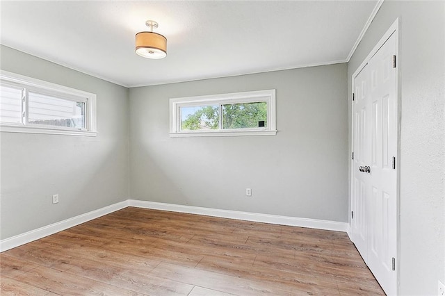 unfurnished bedroom with light hardwood / wood-style flooring and crown molding