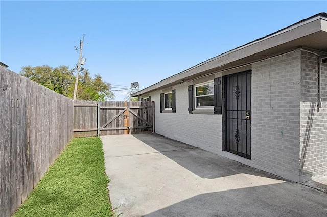 view of side of property featuring a patio area