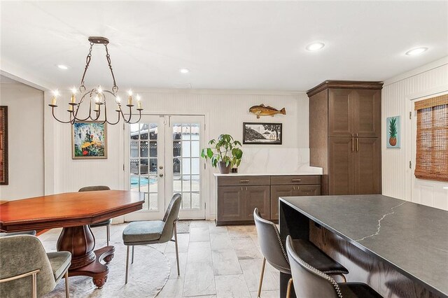 dining room featuring an inviting chandelier and french doors