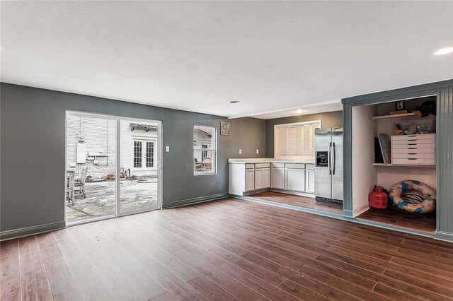 unfurnished living room with dark hardwood / wood-style floors