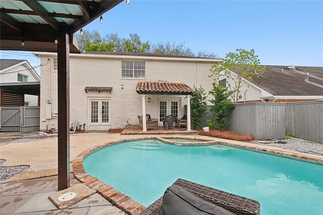 view of pool with an in ground hot tub, french doors, and a patio area