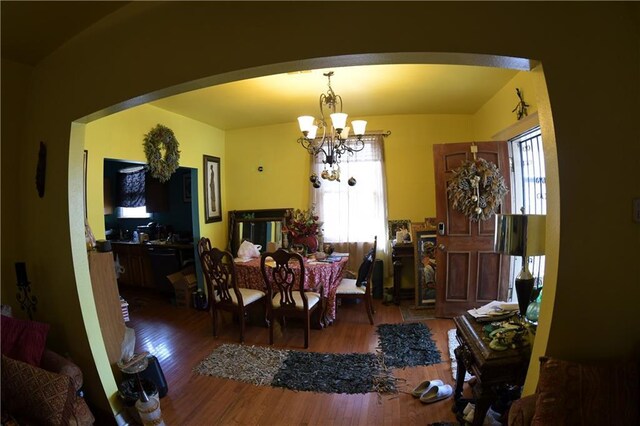 dining space with a notable chandelier, hardwood / wood-style flooring, and plenty of natural light