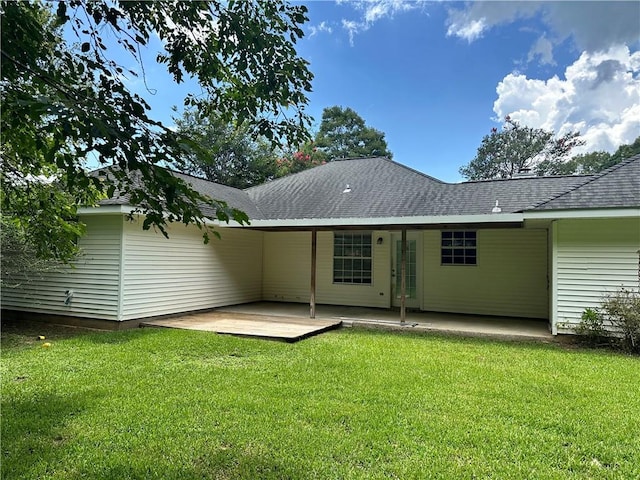 2415 Biron St, Mandeville, LA 70448 - back of house featuring a lawn, a patio, and roof with shingles
