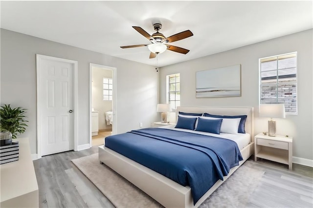 bedroom featuring ceiling fan, wood-type flooring, and connected bathroom