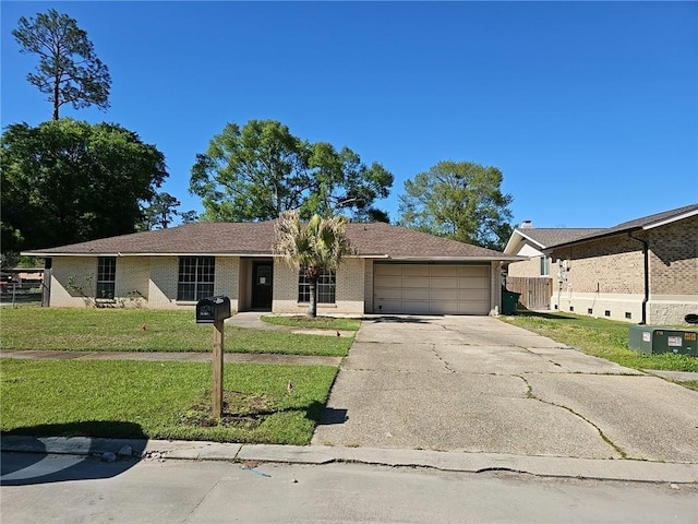 ranch-style house with a garage and a front lawn