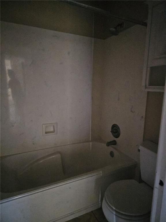 bathroom with toilet and shower / bathing tub combination