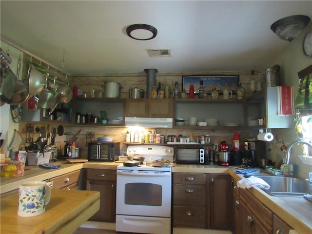 kitchen with white range oven and sink