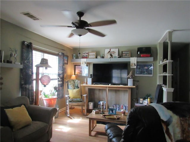 living room with wood-type flooring and ceiling fan