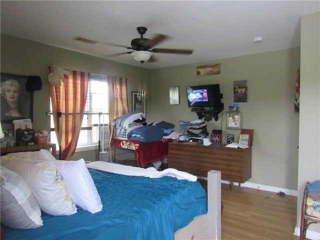 bedroom with hardwood / wood-style floors and ceiling fan