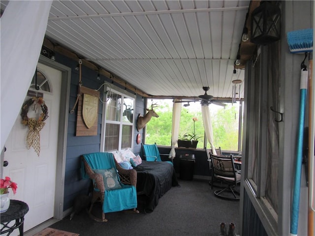 sunroom / solarium featuring ceiling fan