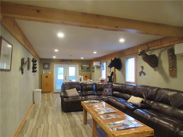 living room featuring beam ceiling, french doors, hardwood / wood-style flooring, and a wall mounted air conditioner