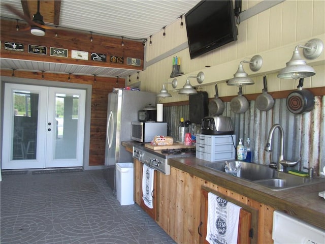 kitchen featuring sink, white dishwasher, ceiling fan, and french doors