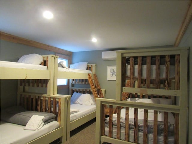 carpeted bedroom featuring a wall mounted AC