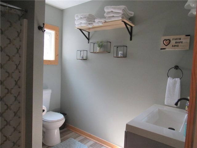 bathroom featuring hardwood / wood-style floors, toilet, and vanity