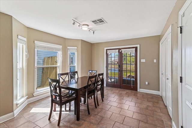 tiled dining room with french doors and track lighting