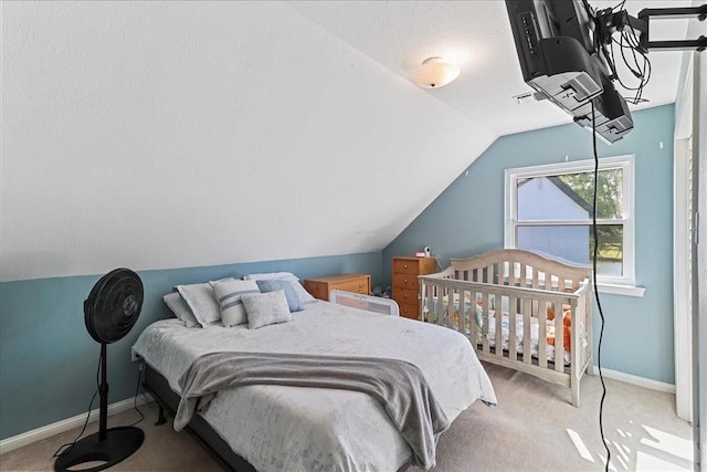 bedroom with light carpet and vaulted ceiling