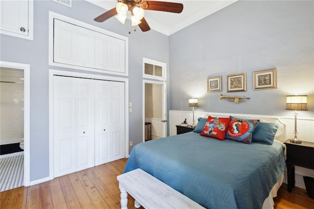 bedroom with connected bathroom, a closet, ceiling fan, and light wood-type flooring