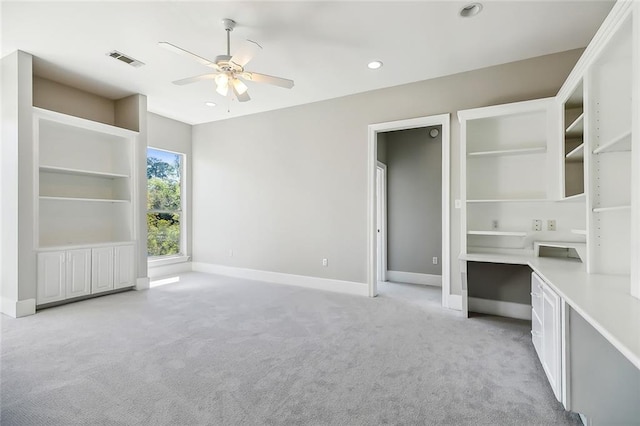 interior space featuring ceiling fan and light colored carpet