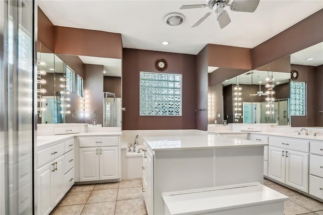 bathroom with plenty of natural light, tile floors, ceiling fan, and oversized vanity