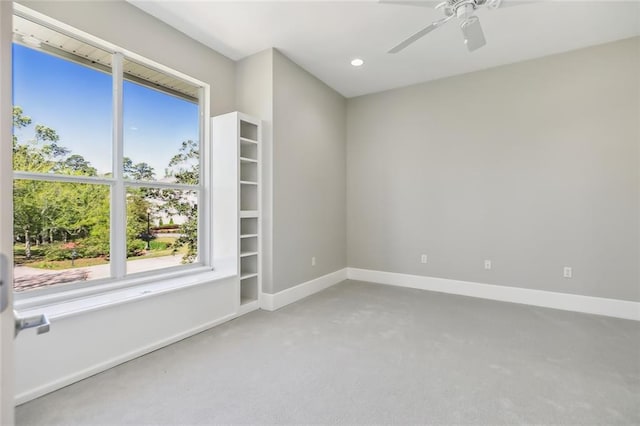 carpeted empty room featuring ceiling fan