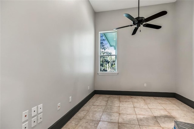 unfurnished room with ceiling fan and light tile flooring