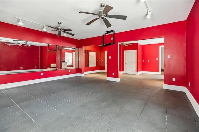 tiled empty room featuring ceiling fan and rail lighting