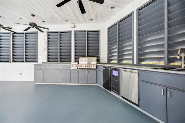 view of terrace with grilling area, an outdoor kitchen, ceiling fan, and sink