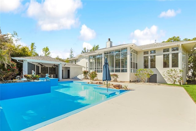 view of pool featuring a patio and a sunroom