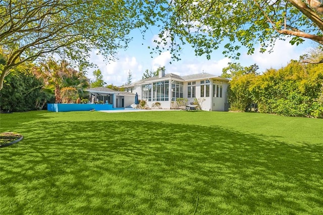 rear view of house with a yard and a patio area