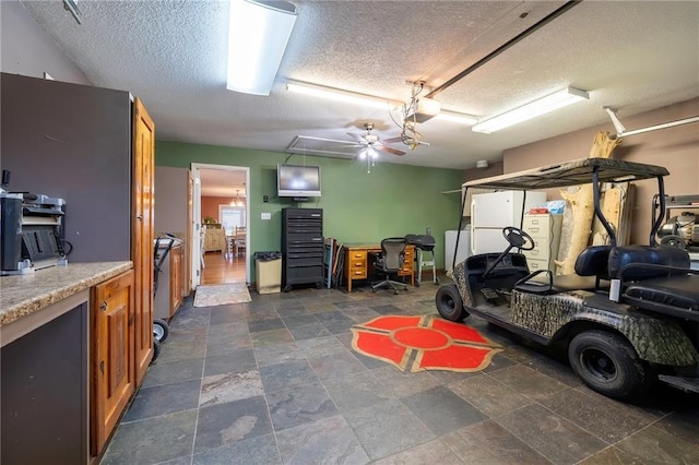 garage featuring ceiling fan and white fridge