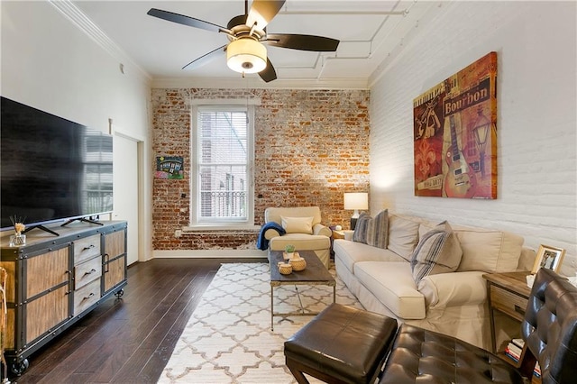 living room featuring brick wall, dark hardwood / wood-style floors, ceiling fan, and ornamental molding