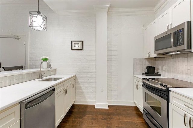 kitchen with hanging light fixtures, white cabinetry, sink, stainless steel appliances, and dark hardwood / wood-style flooring