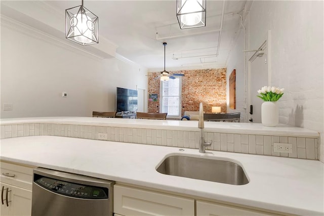 kitchen featuring stainless steel dishwasher, ceiling fan, ornamental molding, hanging light fixtures, and sink