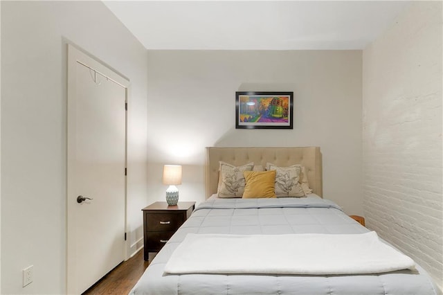 bedroom featuring hardwood / wood-style floors and a closet