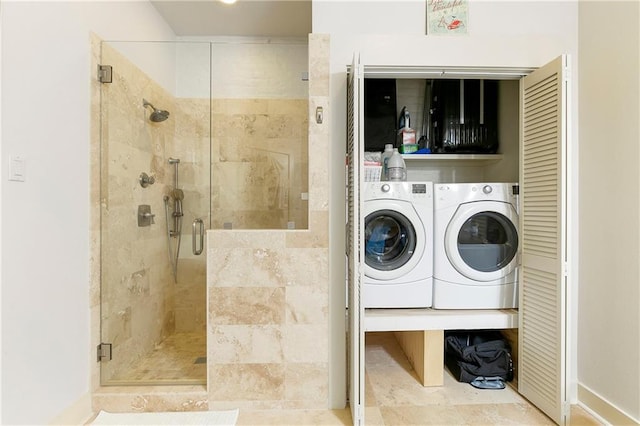 washroom with light tile flooring and washer and dryer