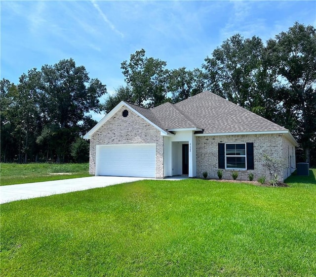 view of front of home featuring a garage and a front lawn