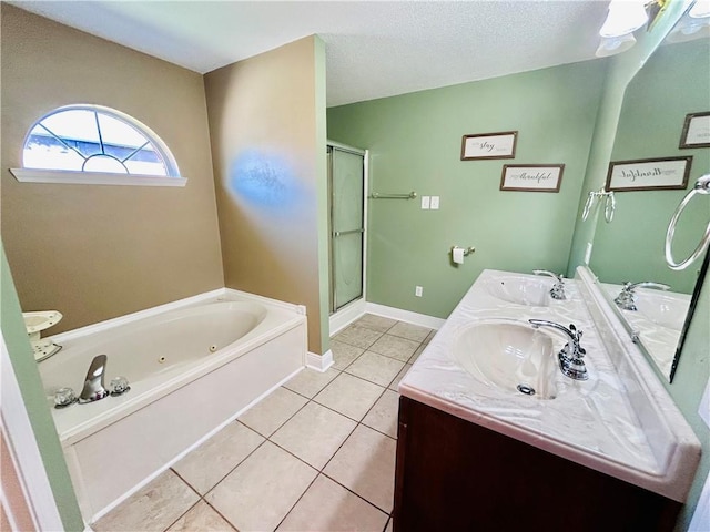 bathroom featuring tile patterned floors, independent shower and bath, vanity, and a textured ceiling