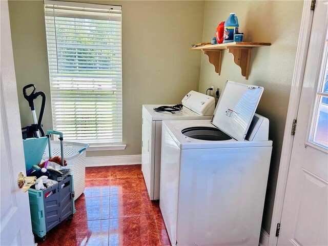 laundry area featuring dark tile patterned floors and separate washer and dryer