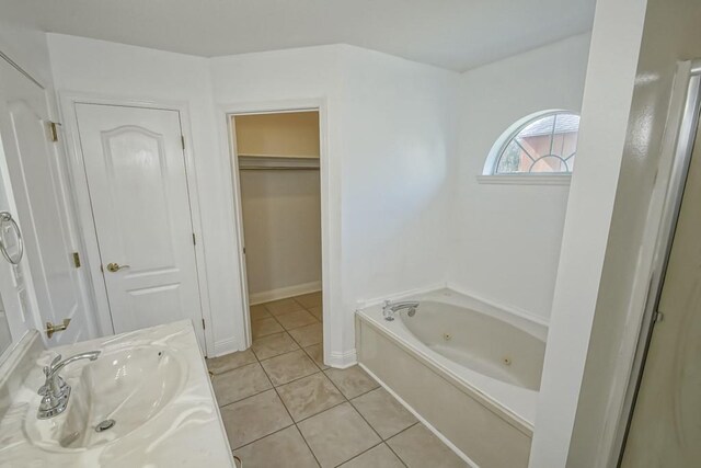 bathroom with vanity, a bathing tub, and tile patterned flooring